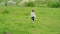 Little girl running through field and falling