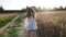 A little girl runs along a wheat field!