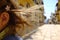 A little girl runs happily in the picturesque Italian village. Close-up of the hair. San Felice Circeo, Lazio, Italy