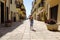 A little girl runs happily in the picturesque Italian village. San Felice Circeo, Lazio, Italy