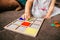 Little girl`s hands playing with a wood mosaic on a sofa. Educational games. Montessori Preschool early develop