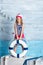 Little girl sailor standing and keeps lifebuoy