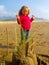 Little girl and sandcastle on sunny beach