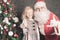 Little girl and Santa Claus at Christmas night