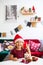 Little girl in Santa hat with Christmas ginger cookies and cup of cacao with marshmallow