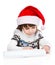 little girl in Santa hat writes letter to Santa. isolated on white background