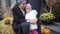 Little girl scared sitting with mom on the street Halloween with pumpkins on the background