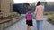 Little girl with school bag or satchel walking to school with mother. Back to school.