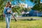 Little girl schoolgirl. Summer in park in nature after school. Writes a smartphone message. Free space for text.