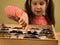 Little Girl Scrutinizes Entomology Collection of Tropical Butterflies