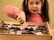 Little Girl Scrutinizes Entomology Collection of Tropical Butterflies