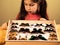 Little Girl Scrutinizes Entomology Collection of Tropical Butterflies