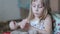 Little girl sculpts figures out of the sand