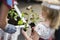 Little girl with seedlings of flowers in plastic pots helps the family in spring outdoor work, planting plants