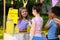 Little girl selling natural lemonade to kids in park. Summer refreshing