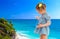 Little girl in a short blue dress on a sea background.