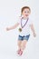 Little girl in shorts with medal on her chest runs