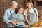 Little girl showing granny and mom recipes on digital tablet