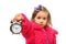 Little girl shows time on round alarm clock