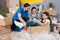 Little girl simulates flight on airplane, sitting in box next to parents. House renovation for sale.