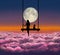 Little girl sit near her dog on the swing. Cheerful pretty young woman sit down and on the swing on the clouds sea looking at the