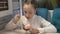 A little girl sits in a cafe and eats chocolate ice cream. Close-up, high detail.