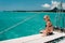 A little girl sits on a catamaran in the Indian ocean. portrait of a girl on a boat in the coral reef of the island of Mauritius