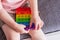 A little girl sits and holds a toy in her hands rainbow pop it fidget toy