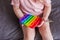 A little girl sits and holds a toy in her hands rainbow pop it fidget toy