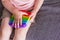 A little girl sits and holds a toy in her hands rainbow pop it fidget toy
