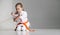 Little girl sits in a kimono on a white background, karate lesson