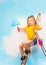 Little girl sits on a metal ladder