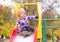 Little girl sits on a slide in the yard