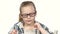 Little girl sits and writes that his notebook. White background. Close up