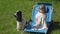 A little girl is sitting in the beach chair wrapped in a towel blanket