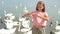 Little girl sitting on the beach with swans