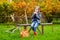 Little girl sitting on a bench on autumn day