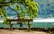 Little girl sitting on the bench and looking on the river scenery