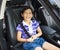 Little girl sitting in the car with seat belt