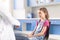 Little girl sitting on chair and looking at doctor in white coat