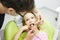 Little girl sitting on dental chair