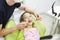 Little girl sitting on dental chair