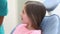 Little girl sitting in the dental chair