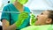 Little girl sitting in dentist chair, letting to cure her teeth, caries removal