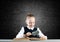 Little girl sitting at desk with magnifier