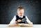 Little girl sitting at desk with magnifier