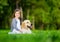 Little girl sitting on the grass with labrador retriever