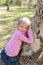 Little girl sitting in a gum tree