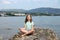 Little girl sitting on a rock and meditates