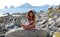 Little girl sitting at rocks at ocean front in Los Cabos Mexico resort cliff sea